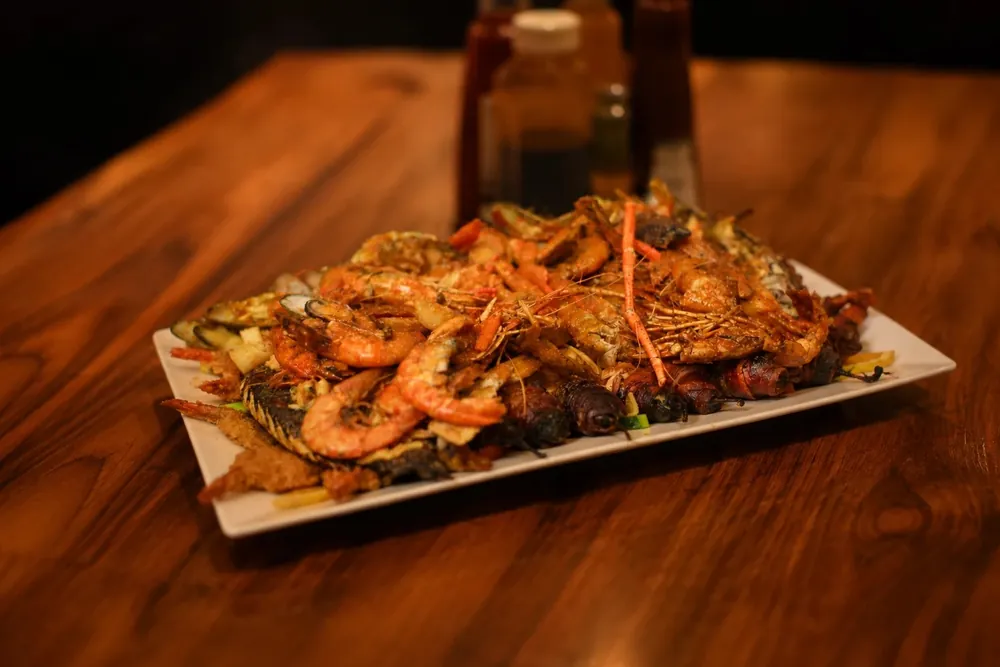 Parrillada de Mariscos — family-size seafood platter with shrimp, crab legs, mussels and whole fried fish
